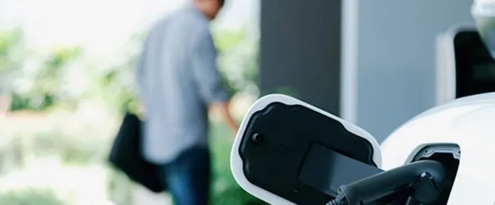 Person charging car at home